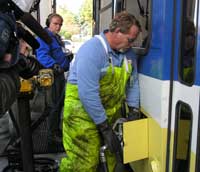 Employee fills bus tank with biodiesel fuel