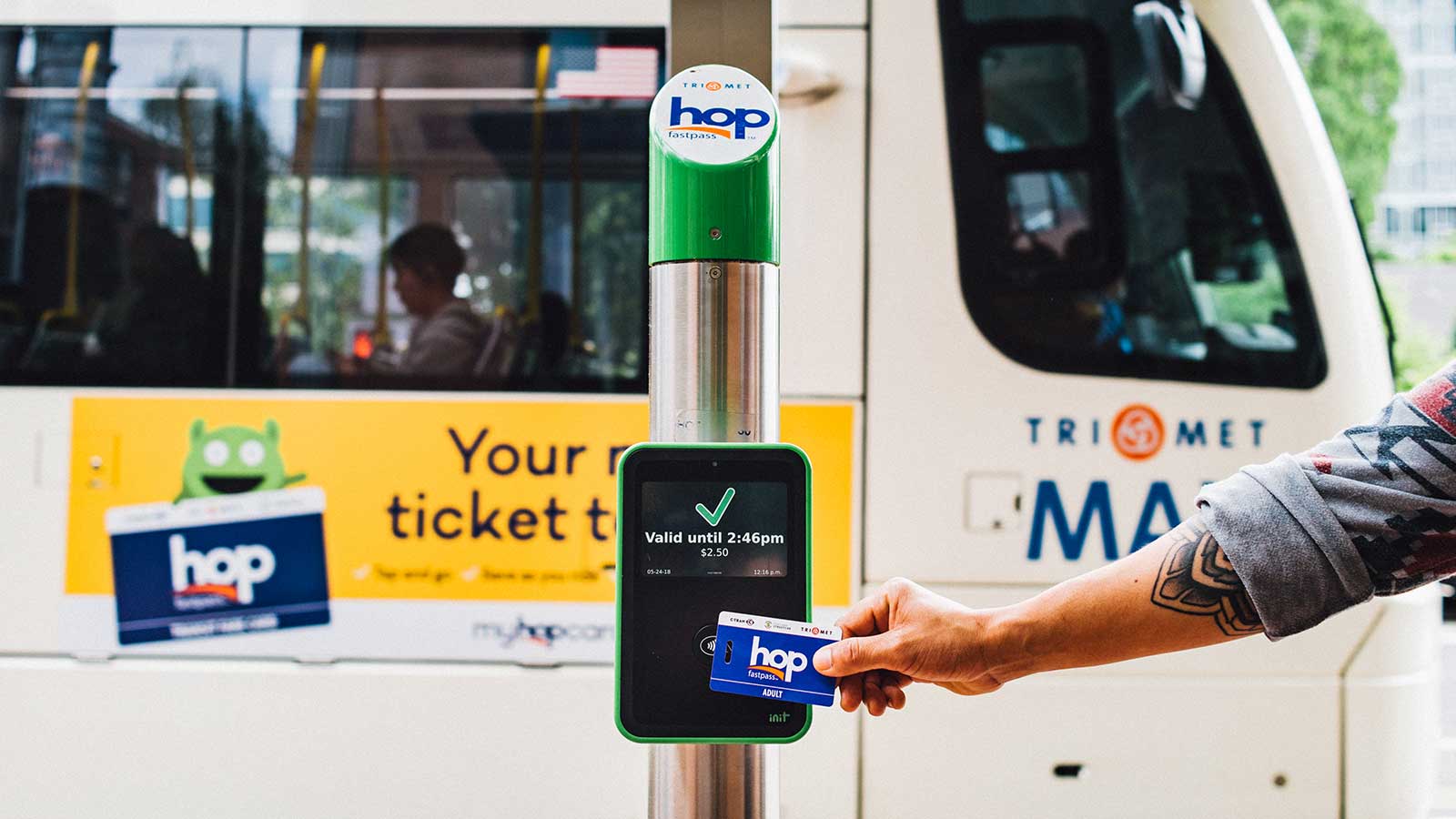 Rider tapping a Hop Fastpass card before boarding