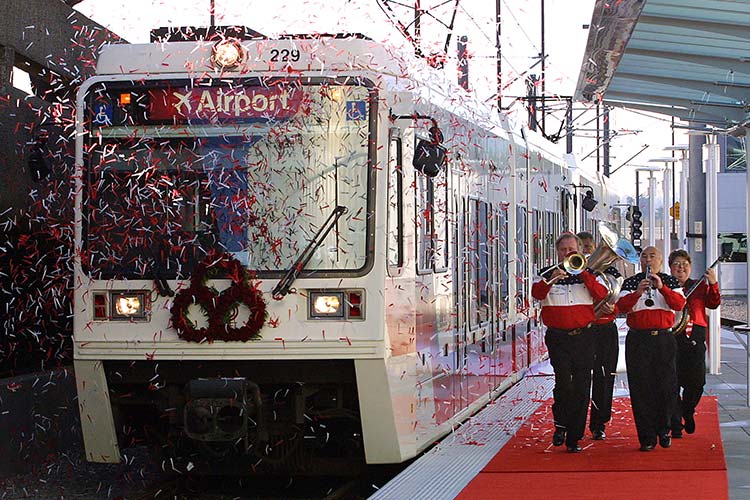 Airport MAX Red Lilne grand opening with a small marching band in TriMet red, white, and black colors