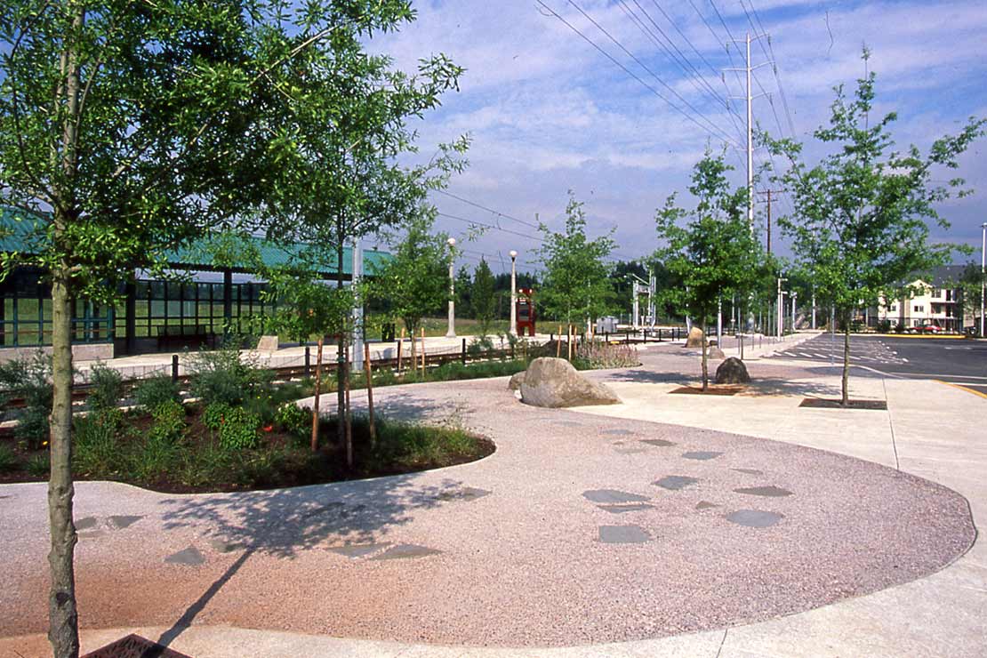 Landscaping at the MAX station includes a pebble path with embedded smooth pavers