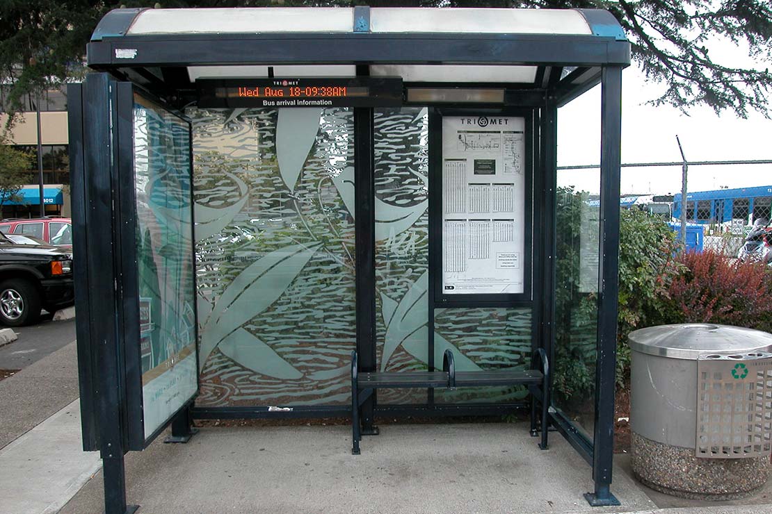 Falling leaves etched into glass on bus shelter