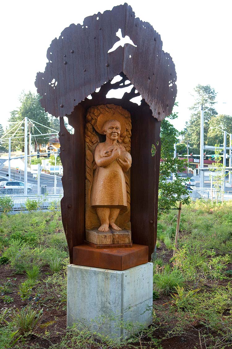 'To Grandmother's House' - a multi-media sculpture with a carved wooden woman