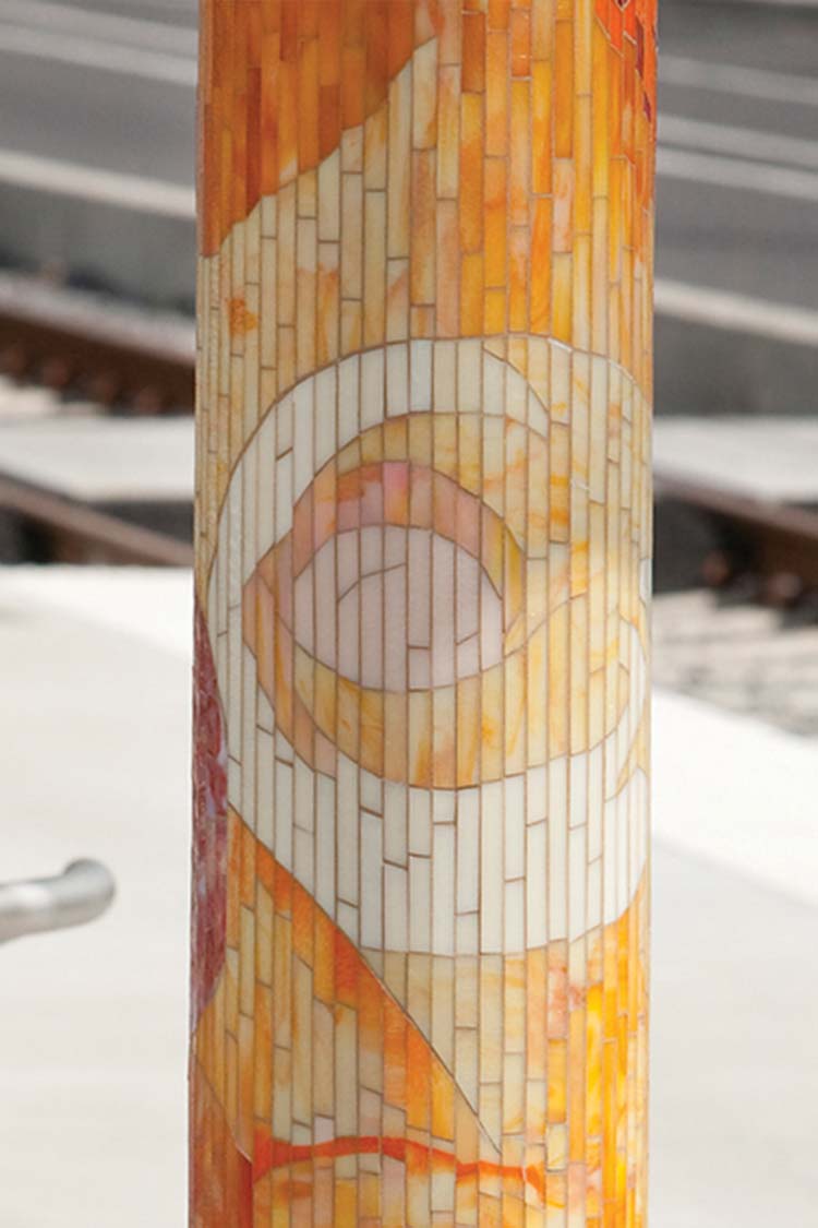 'Journey Through Time' bus shelter column decorated with mosaic roses in white and orange