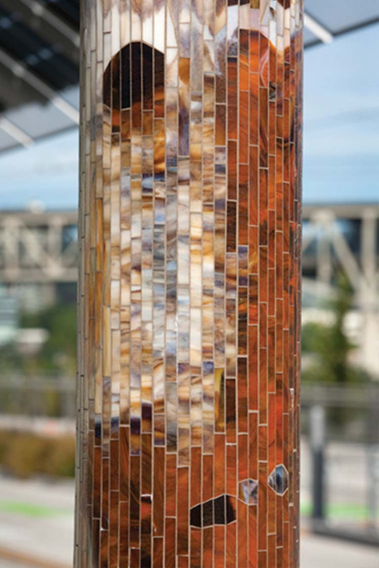 'Journey Through Time' bus shelter column with tree bark pattern made in copper tones