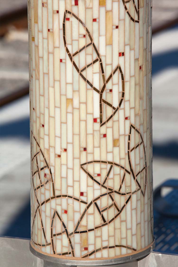'Journey Through Time' mosaic bus shelter column decorated with inset canoe shapes
