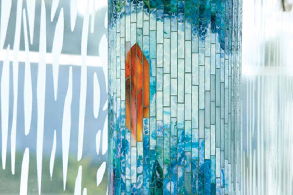 'Journey Through Time' bus shelter column with light blue tile mosaic inspired by the Johnson Creek restoration project