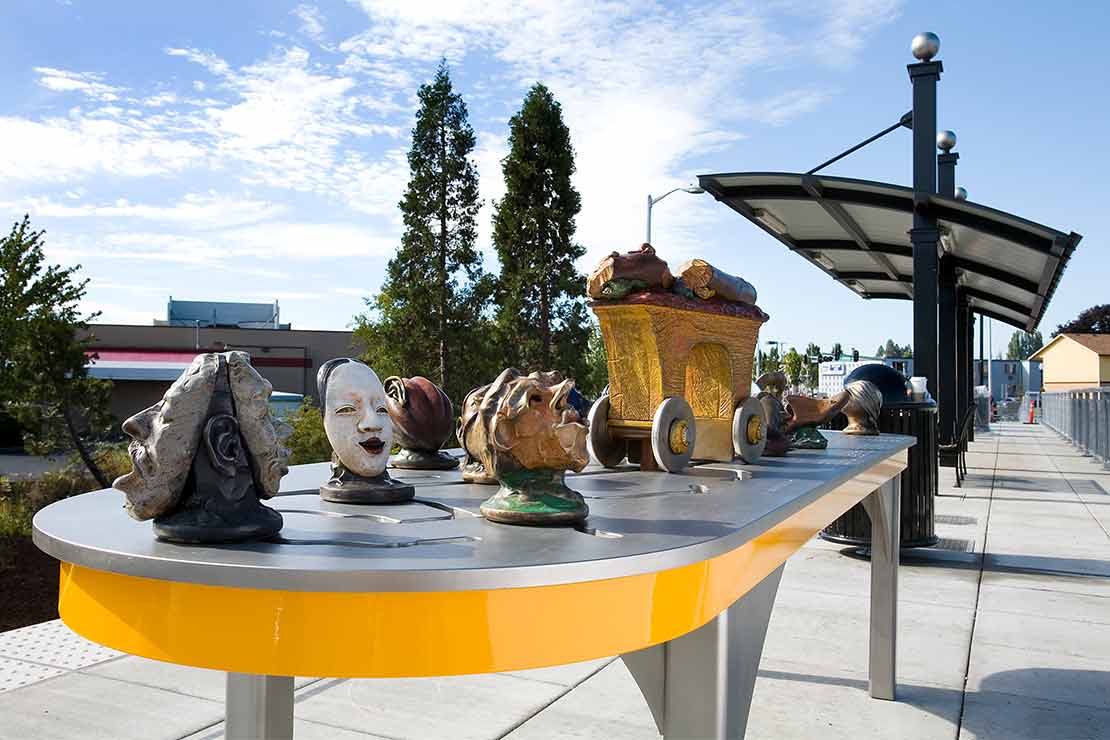 The Beaverton Interactivator sculptural heads with masks on a metal table