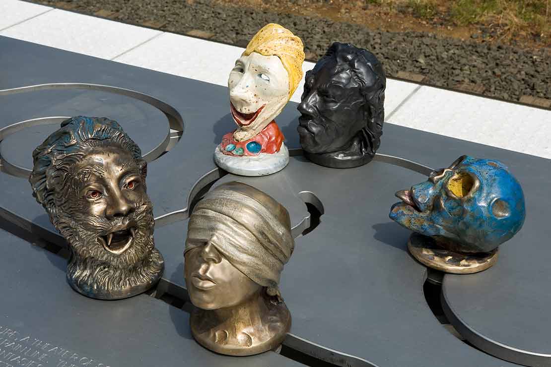 The Tigard Interactivator detail - 5 heads with masks including blind justice