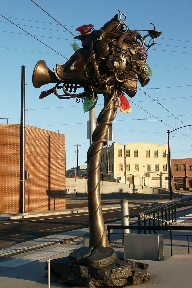 Second Growth metal sculpture with twisted musical instruments in the branches of a tree