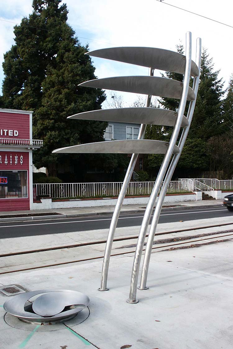 Prowform - tall metal sculpture with 3 poles supporting 4 large leaves